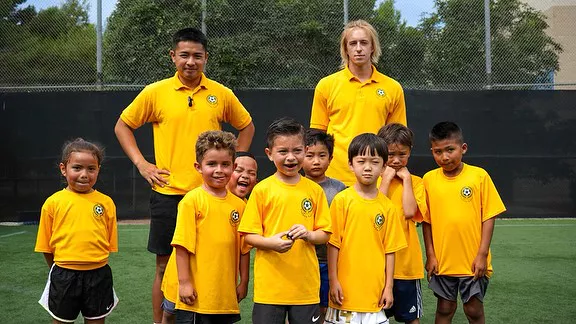Young soccer players practicing shooting skills